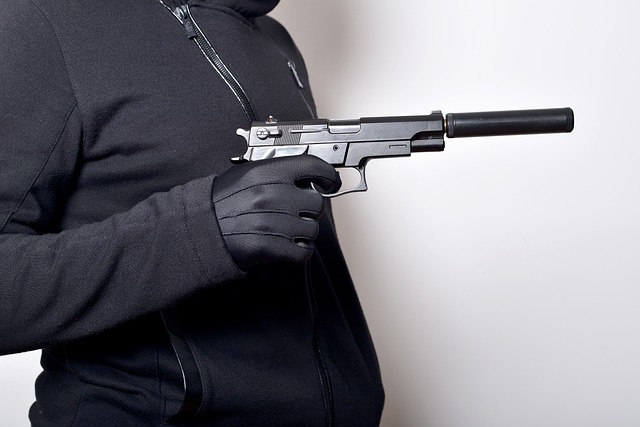 A man holding a handgun that may leave gunshot residue